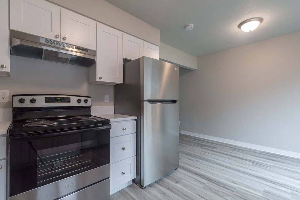 a kitchen with a stove and a refrigerator