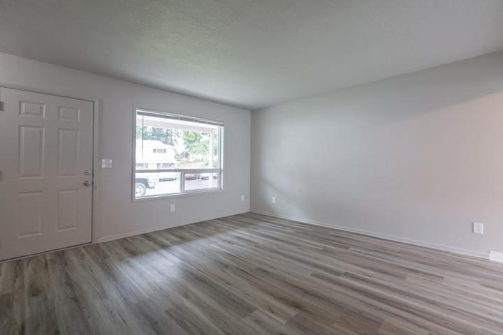 an empty room with a door and a window