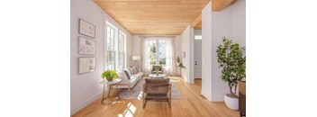 a living room filled with furniture and a large window