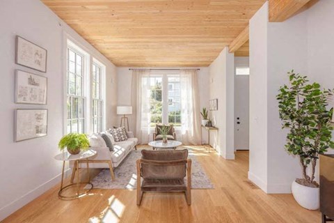 a living room filled with furniture and a large window