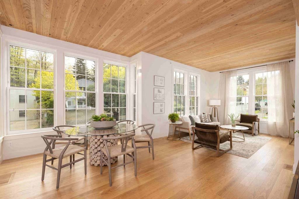 a living room filled with furniture and a wooden ceiling