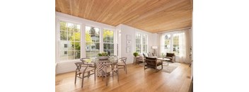 a living room with a glass table and chairs