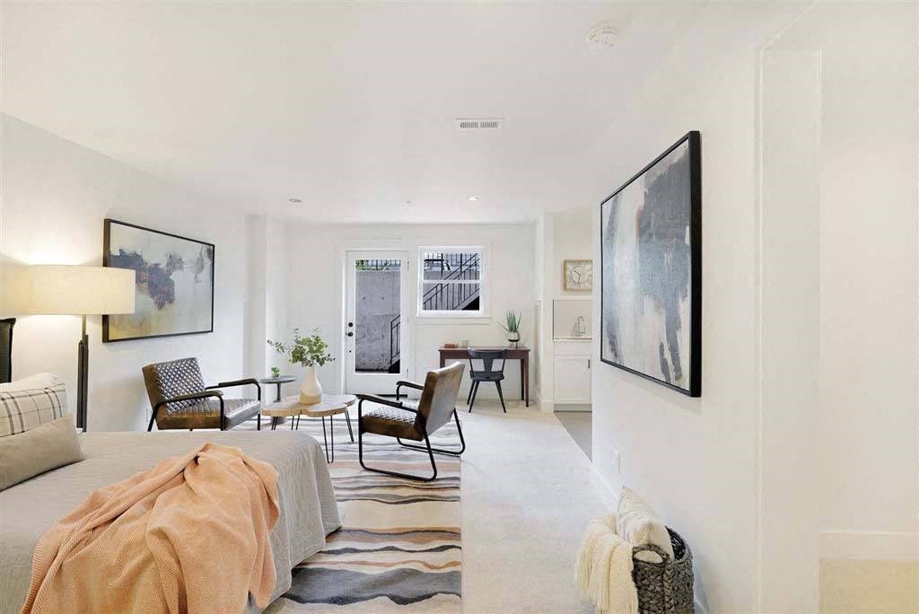 a bedroom with a bed and a chair in a room