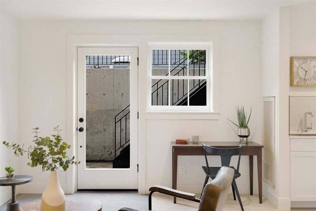 a living room with a door and a window