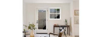 a living room with a table and a chair