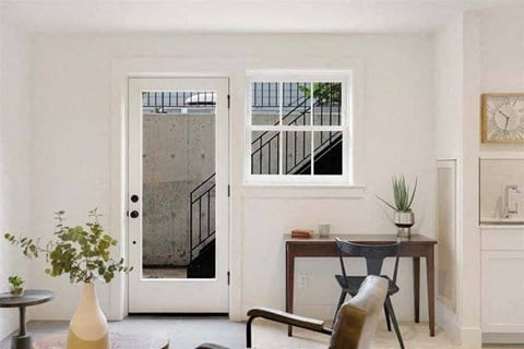 a living room with a table and a chair