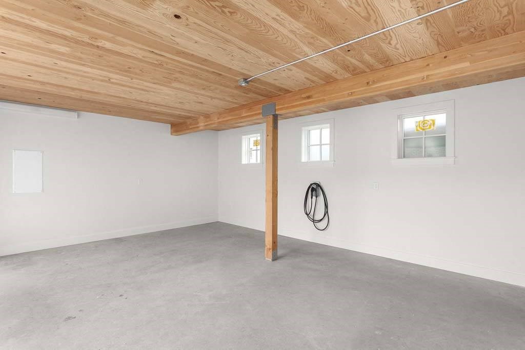 a large white garage with a wooden ceiling