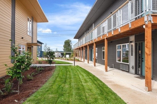 a grassy area in front of a building