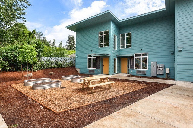 a blue house with a picnic table in front of it