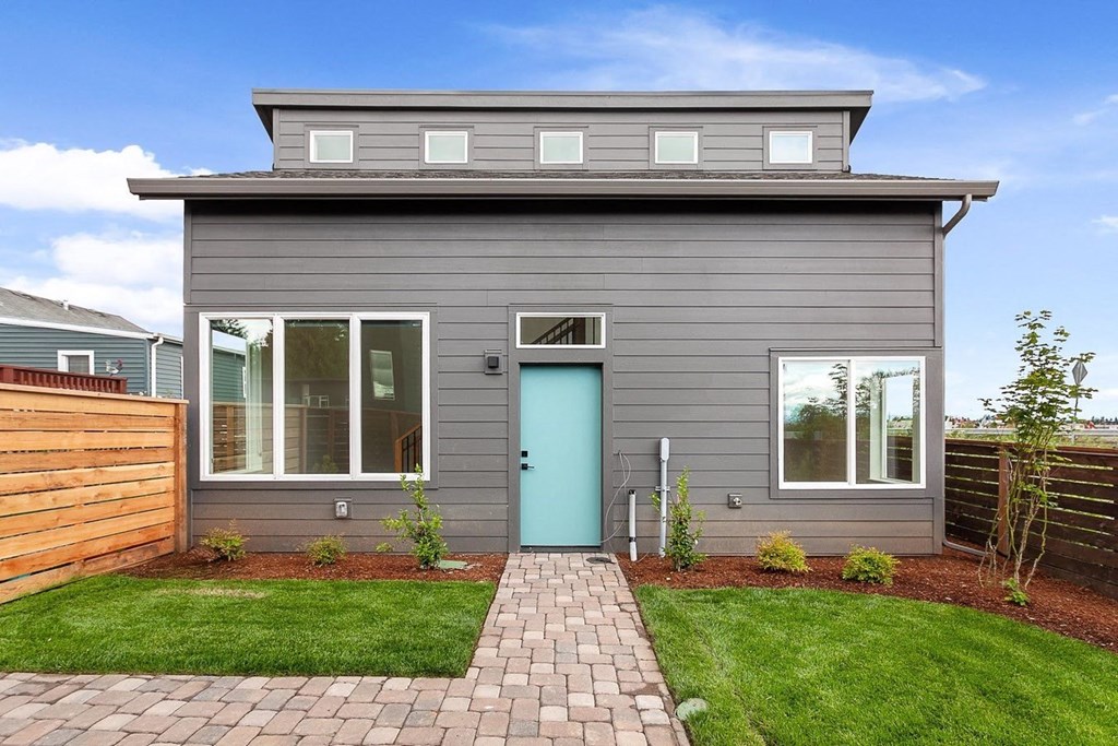 a gray house with a blue door