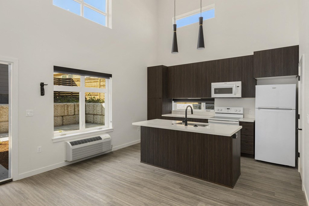 view of the kitchen in a bedroom plus den unit