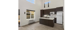 a kitchen with a sink a stove and a refrigerator