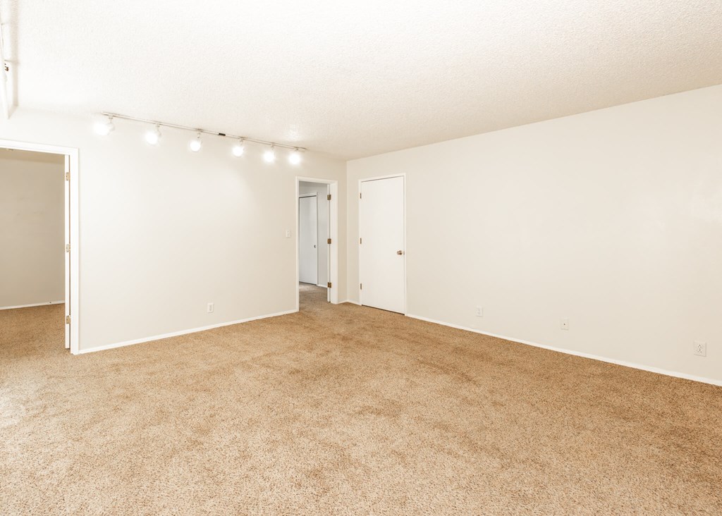 A room with carpeted floor and white walls.