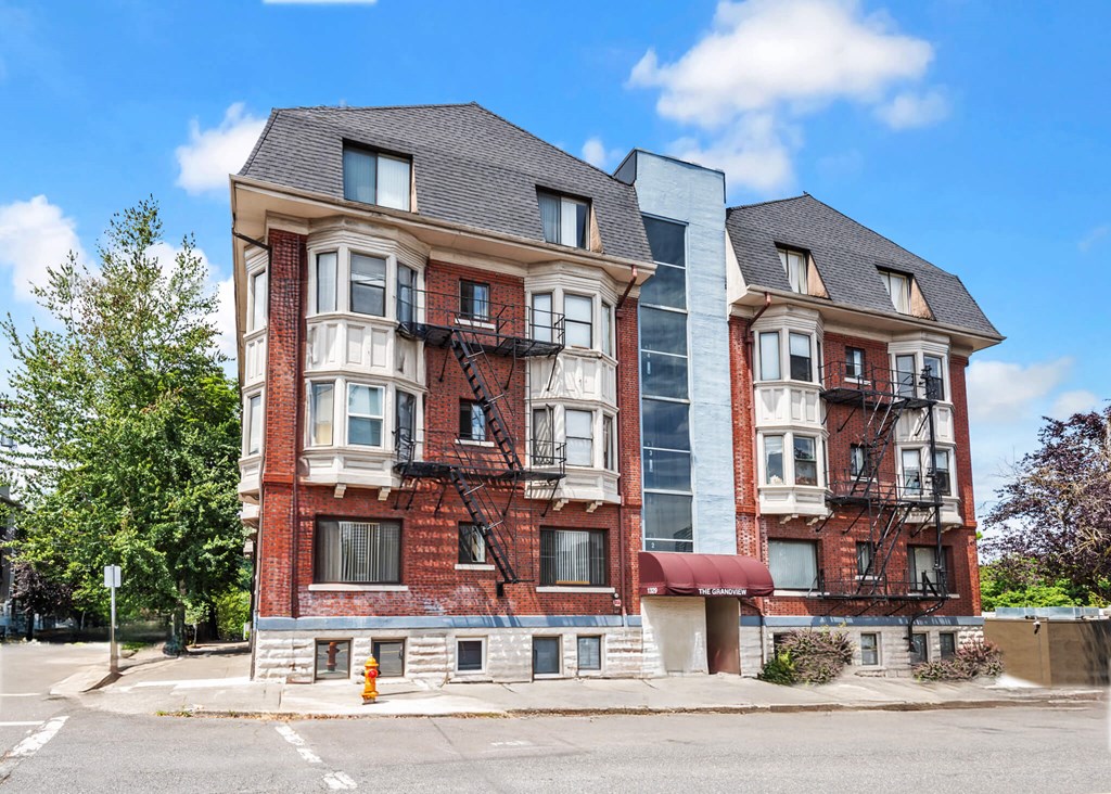 A red brick building with a black metal fire escape.