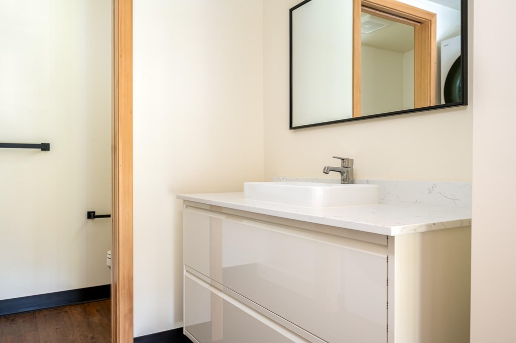 A white sink with a mirror above it.