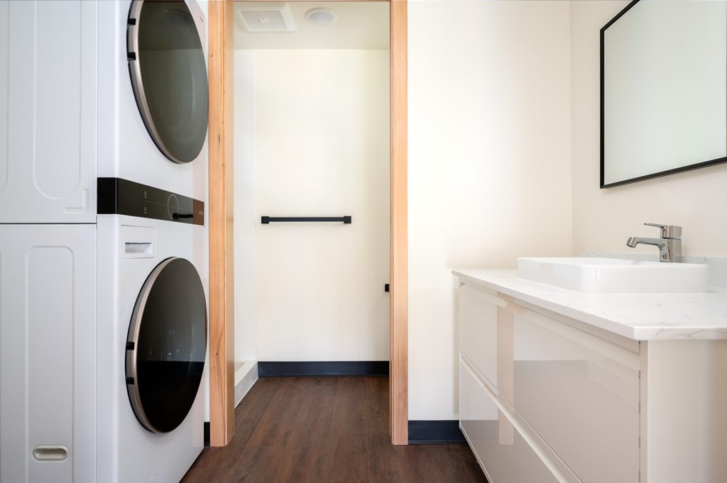 A white sink is on a counter in a bathroom.