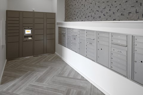 A row of mailboxes are lined up on a wall.