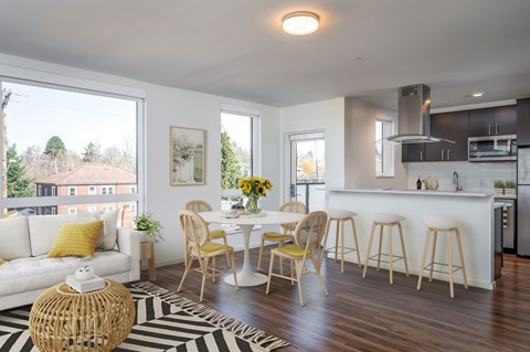 A modern kitchen with a dining table and chairs.