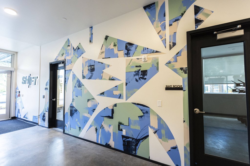 a wall with a geometric design in front of a door at Shift, Portland, 97217