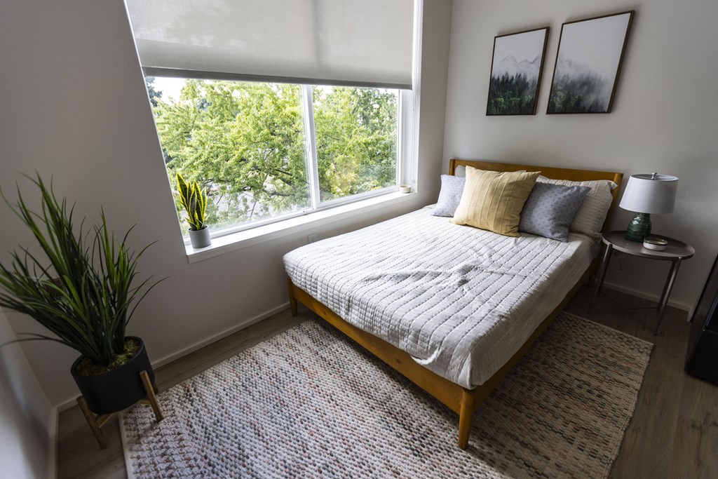 a bedroom with a bed and a large window at Shift, Oregon