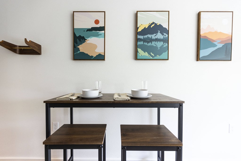 a dining room with three tables and three paintings on the wall at Shift, Portland Oregon