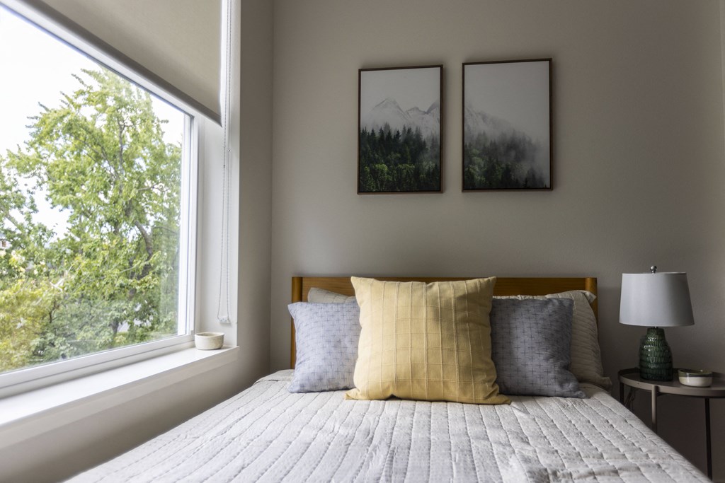 a bedroom with a bed and a large window at Shift, Portland, 97217