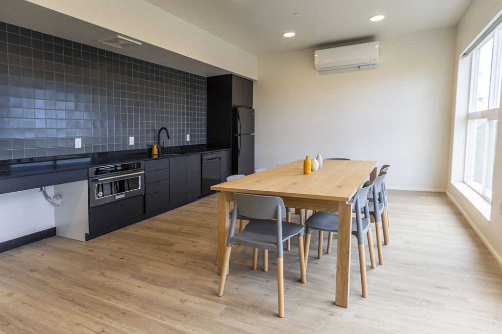 a kitchen and dining room with a wooden table and chairs at Shift, Oregon, 97217