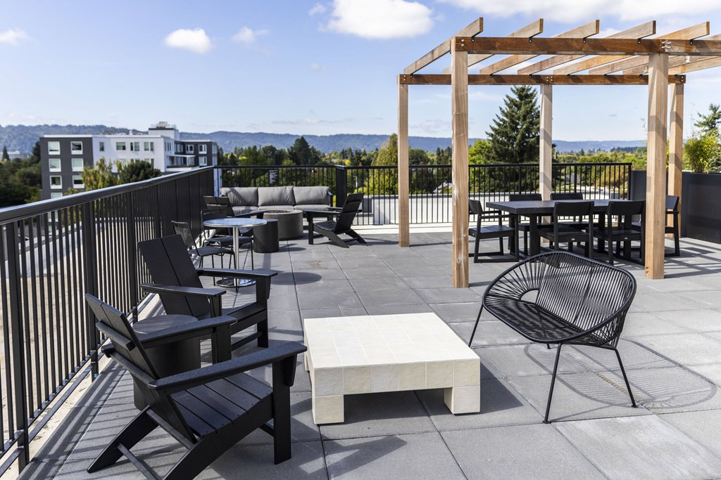 the deck on the top of a building with chairs and tables at Shift, Portland, 97217