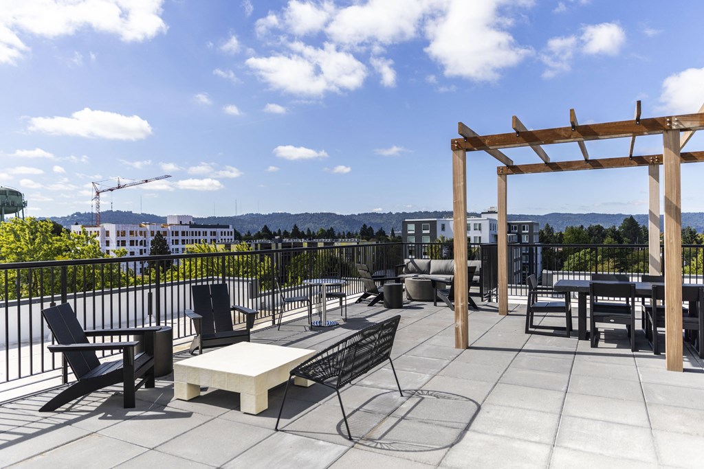a rooftop patio with tables and chairs and a view of the city at Shift, Portland, OR