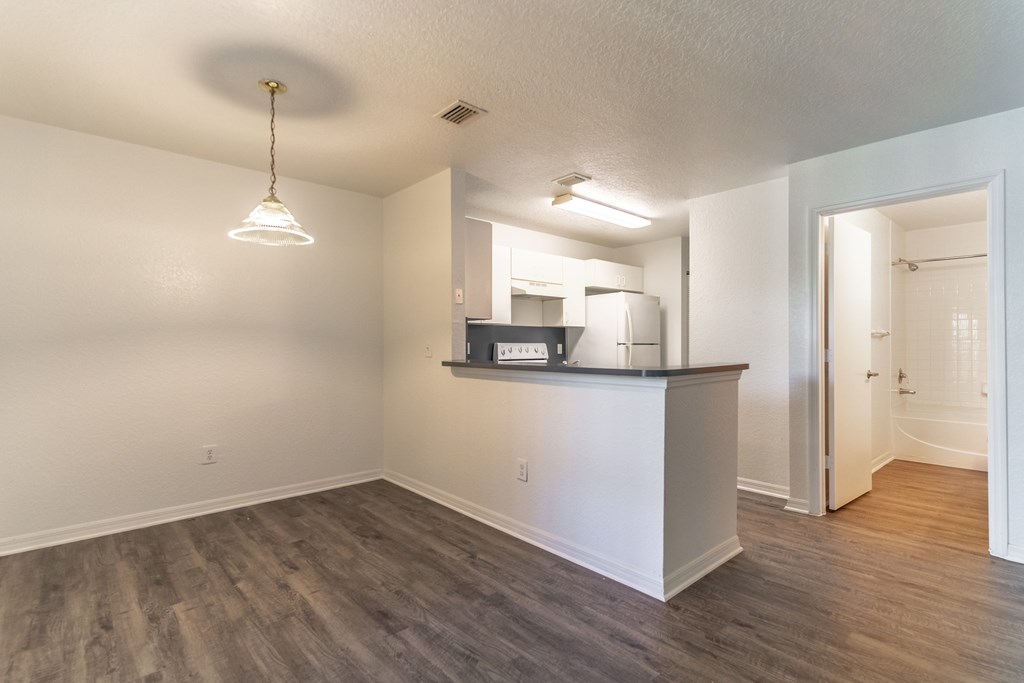 A room with a bar counter and a mirror.