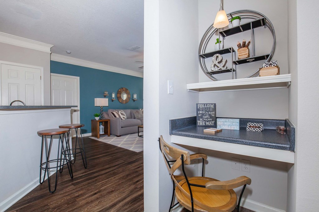 a living room with a bar and a kitchen with a table and chairs at Carrington Place at Wildewood, Columbia, 29223  