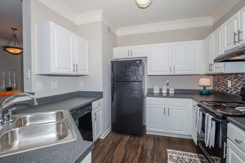 a kitchen with stainless steel appliances and white cabinets