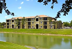 a large building with a lake in front of it