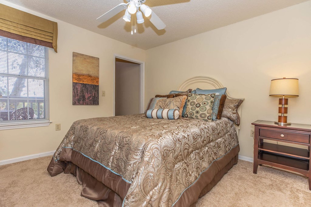 a bedroom with a bed and a ceiling fan at Arbors at Windsor Lake, Columbia South Carolina   