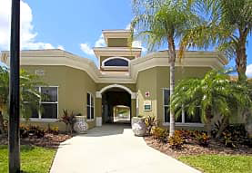a house with a walkway and a palm tree