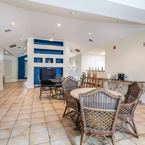 a dining room with tables and chairs and a bar a dining room with tables and chairs and a bar at Waterford at Sterling Place Apartments, Pennsylvania
