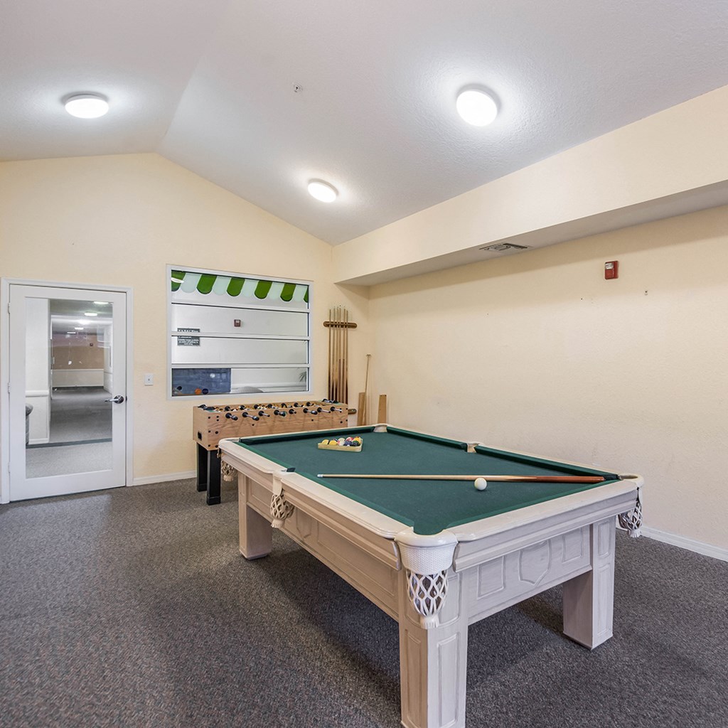 a games room with a pool table and foosball