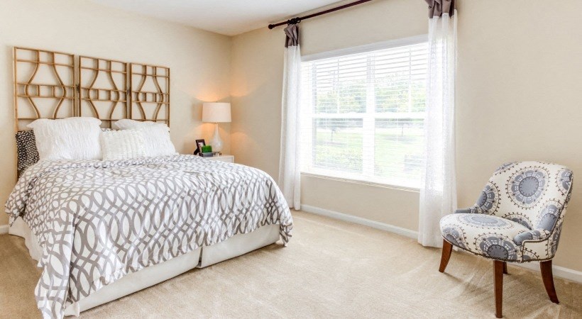 a bedroom with a bed and a chair