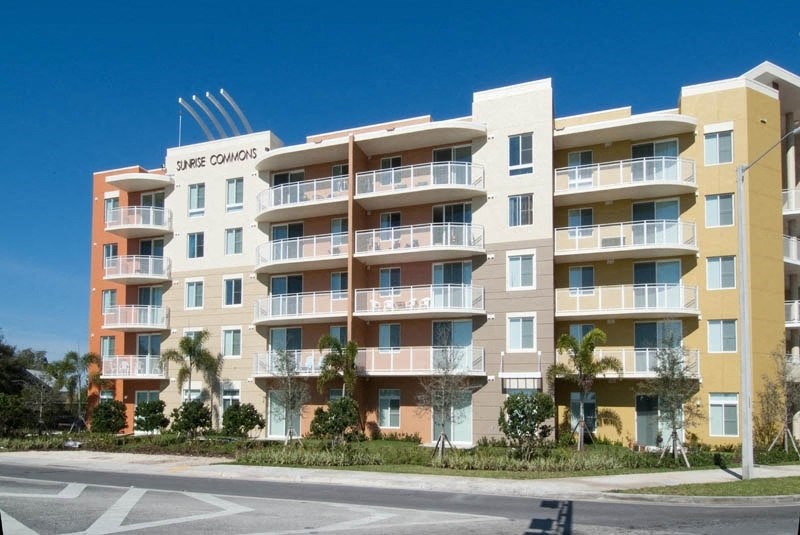 a large apartment building on the side of a street