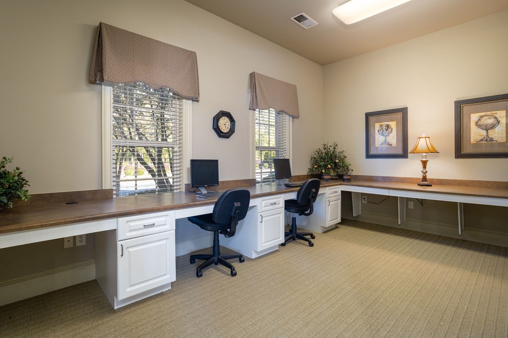 an office with two desks and two chairs