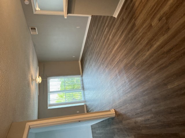 a staircase with a wood wall and a window