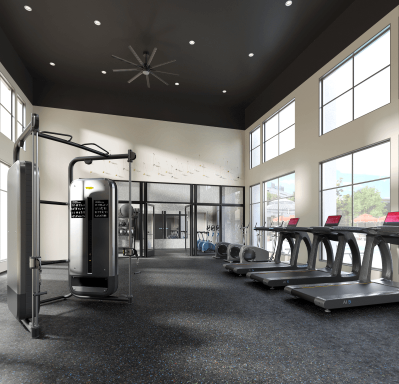 a gym with cardio equipment and windows in a building