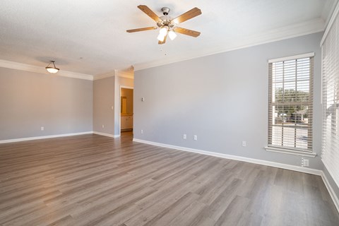 a living room with hardwood floors and a ceiling fan