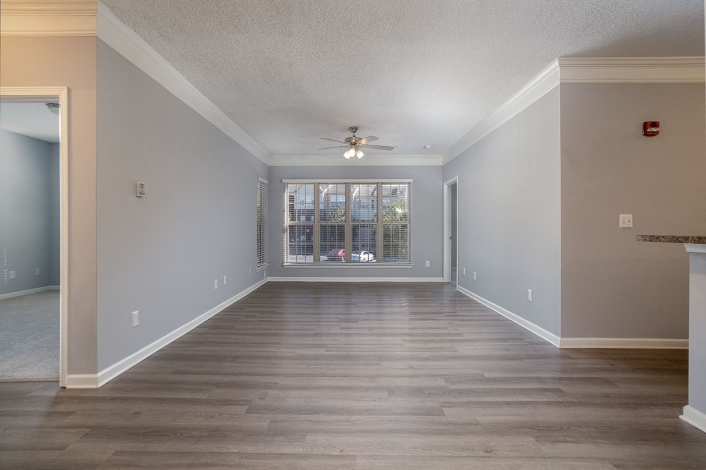 a bedroom with hardwood floors and a ceiling fan