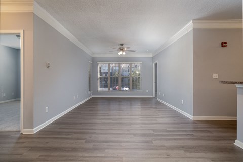a bedroom with hardwood floors and a ceiling fan