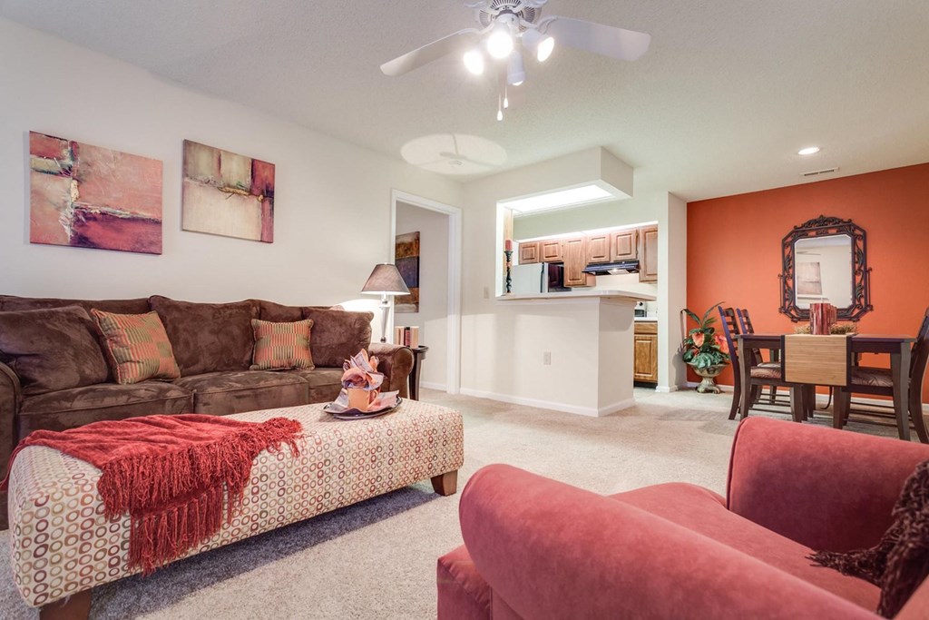 a living room with a brown couch and a red chair at Arbors at Windsor Lake, South Carolina, 29223