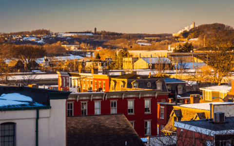 a view of a city with roofs covered in snow