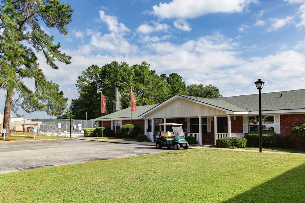 a building with a golf cart parked in front of it a building with a golf cart parked in front of it at Brandywine Townhomes, Goose Creek, SC