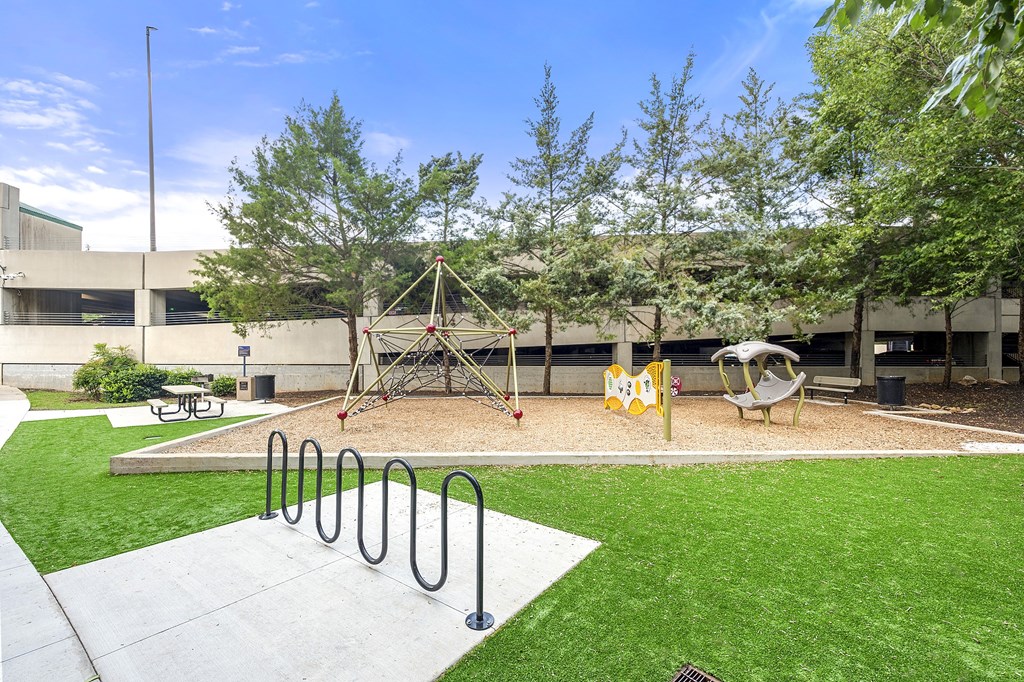 A playground with a swing set and a slide.