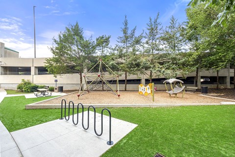A playground with a swing set and a slide.